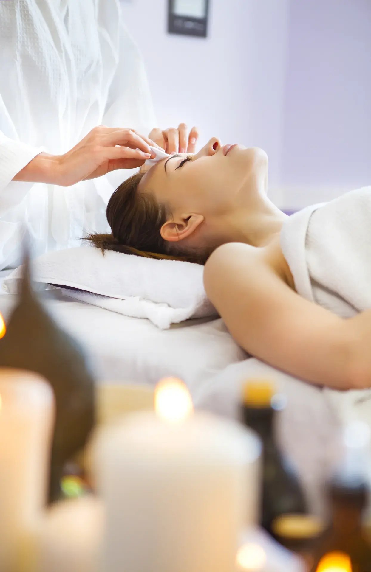"Spa therapist applies aromatherapy protocols relaxing massage essential oils professional well-being"